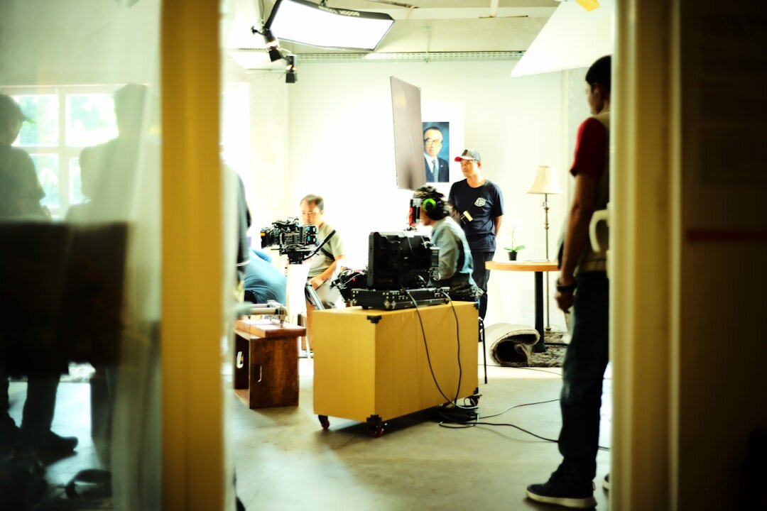 Wide shot of a television news studio set with desk and cameras