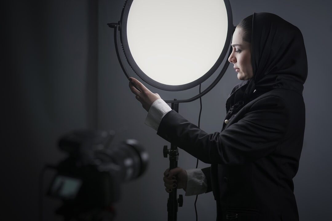 Female lighting technician adjusting a studio softbox