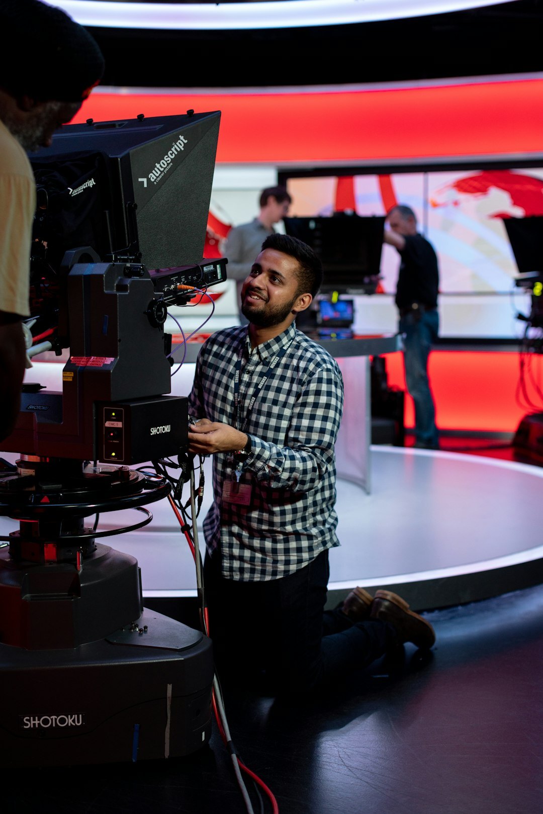 Male instructor explaining camera framing in a TV studio